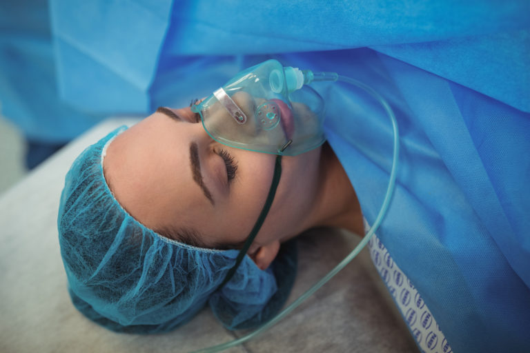 General anesthesia - female patient with oxygen mask in operation theater